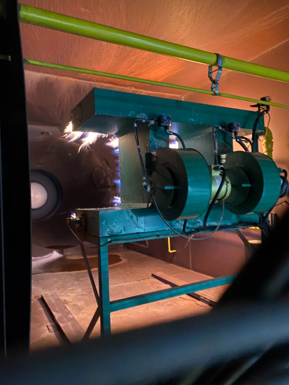 Retrofitted burner firing into a process vessel after a propane-to-natural-gas conversion