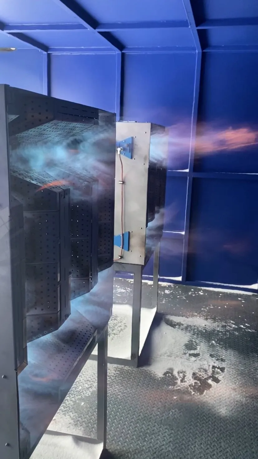 Two burners on high fire inside a blue-painted heater enclosure in Val-d'Or, Québec