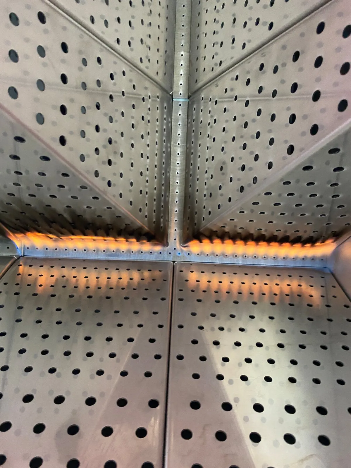 Burner ports glowing inside the perforated plenum of a custom process heater