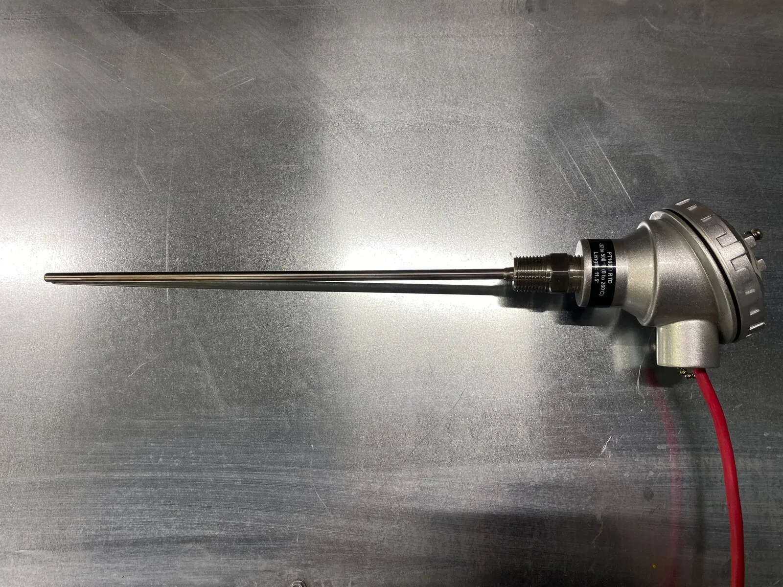 PT100 RTD temperature probe with a stainless connection head and red lead