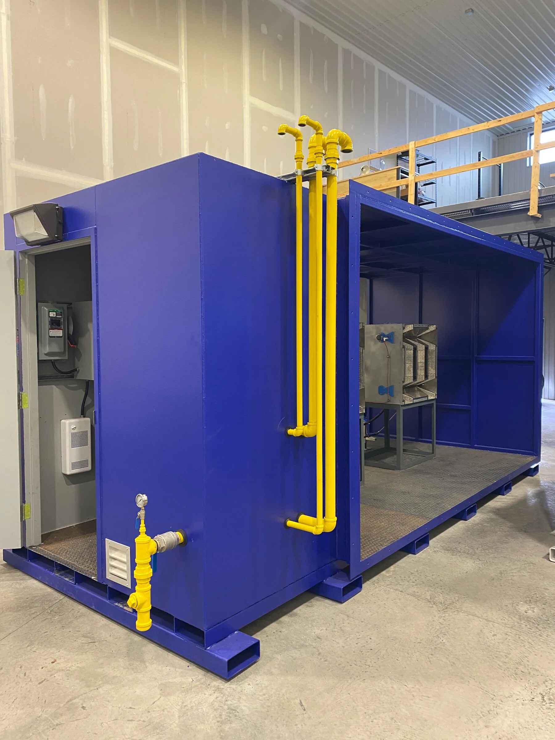 Mine air heater with its gas train risers and control cabinet, open end showing the burner assembly